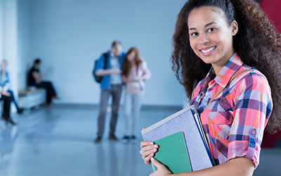 Female student in school holding books