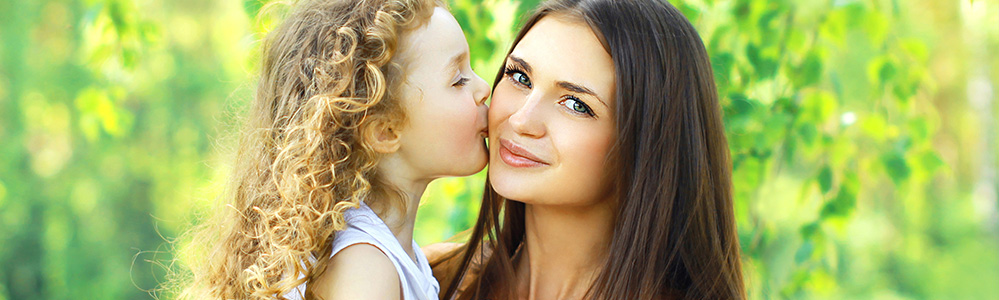 Child giving mother a kiss